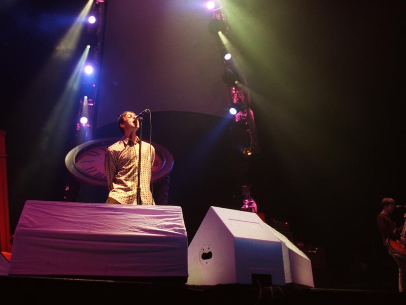 Liam Gallagher on stage at Sheffield Arena in 1997.
