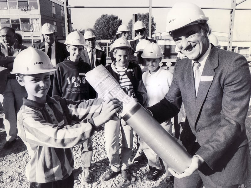 Pupils Alton Milton, aged 13, helps Councillor Peter Price to bury a time capsule at Waltheof School, Sheffield, in October 1989