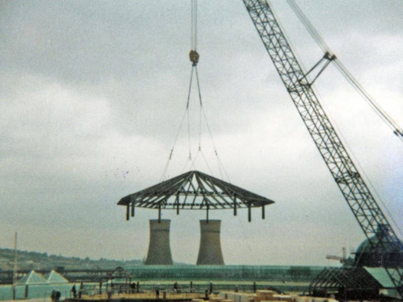 The framework of the famous dome, weighing 25 tons without the glass, is lifted into place at Meadowhall shopping centre, Sheffield, in August 1989. The cooling towers at Blackburn Meadows power station can be seen in the background.