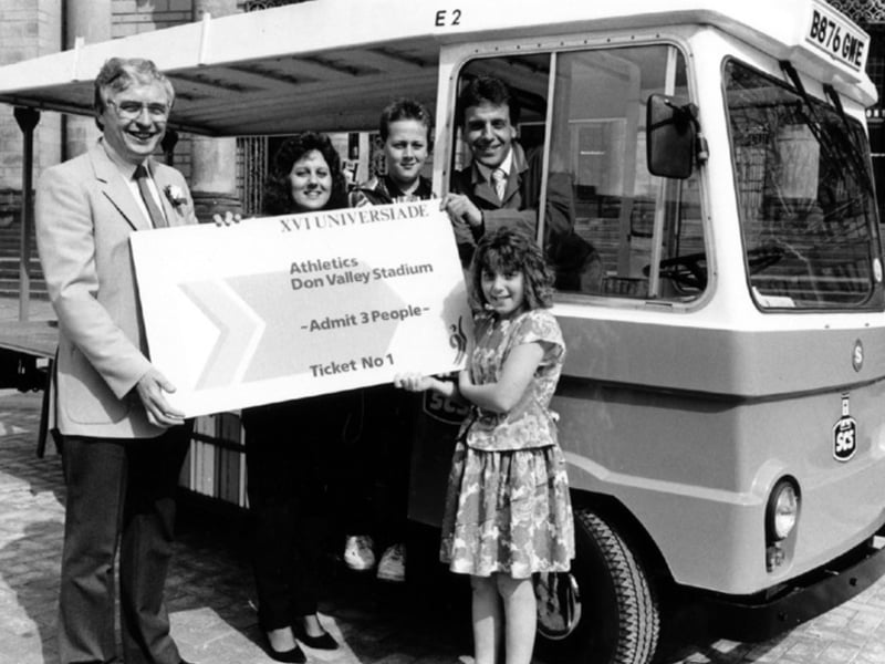 Ray Gridley handing over the Ticket to Sheffield and Ecclesall Co-op milkman, Alan Smith who became the first person to book for the World Student Games with wife Gillian; children Richard and Kerry, in 1991. Photo: Sheffield Newspapers