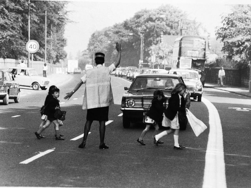 Beryl Davies helps children cross outside the Richmond House and Far Headingley Preparatory School, Otley Road, Leeds, in June 1975