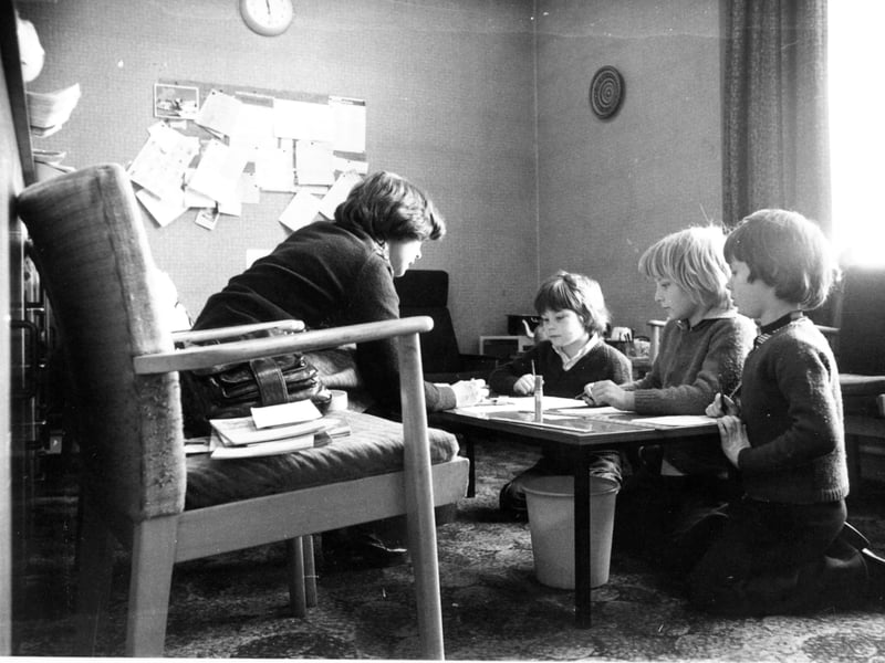 A teacher at Park Spring Primary School, Leeds, uses the staffroom to teach pupils due to overcrowding, in March 1977