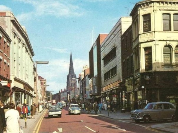 This scene is of Church Street / Friargate in 1960 showing the cars and shops of the time.