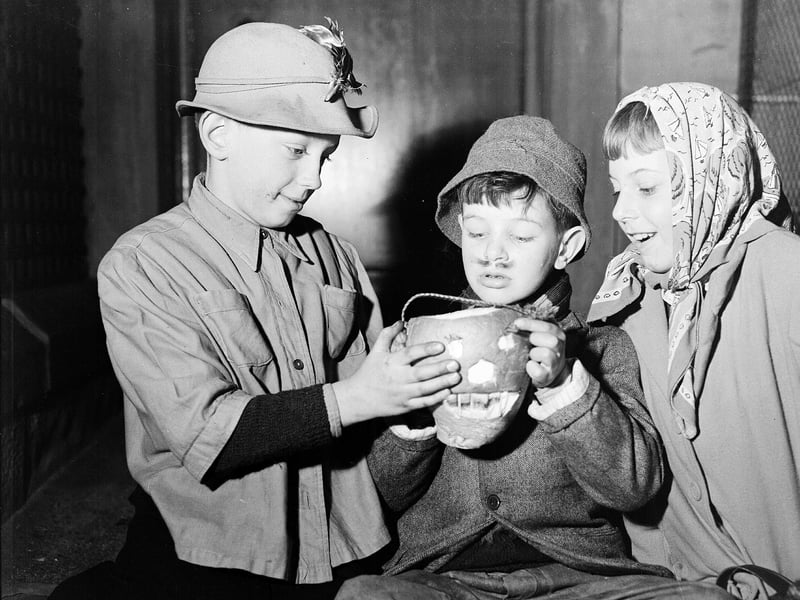 Young Edinburgh guisers warm their hands over their turnip lanterns at Halloween 1956.