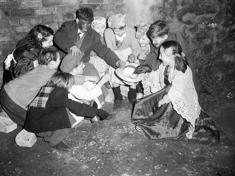 Guisers in Edinburgh - children count the money they made from guising in 1951.