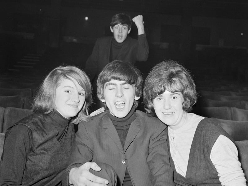 Paul McCartney, of the Beatles, feigns rage while George Harrison 'gets the girls', at the Gaumont Theatre, Doncaster, in December 1963