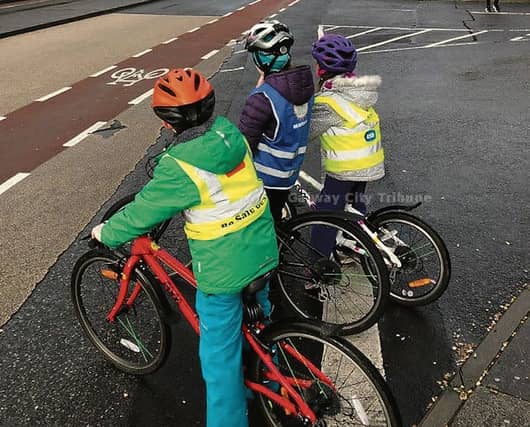 Three schoolchildren ready to join the Knocknacarra cycle bus.