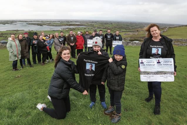 Mina McNamara, wife of the late Paul McNamara, with her niece Caoimhe Clancy and nephews Mikey and Matthew Clancy, and behind family members, friends and organisers, at Corcomroe Hill for the launch of the Paul McNamara Memorial Walk Fundraiser which takes place this Sunday. Photo: Joe O'Shaughnessy.