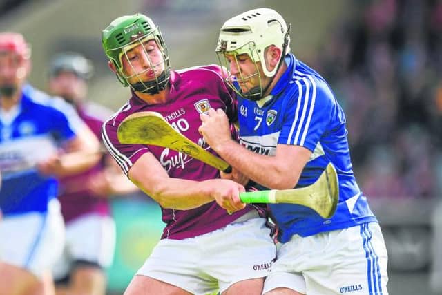 Galway attacker Niall Burke tries to halt the progress of Tom Delaney of Laois during Sunday's Leinster championship quarter-final at O'Moore Park.