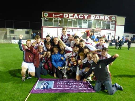 The players and management of NUI Galway Soccer Club celebrate after capturing the Michael Byrne Cup in Eamonn Deacy Park on Thursday last.