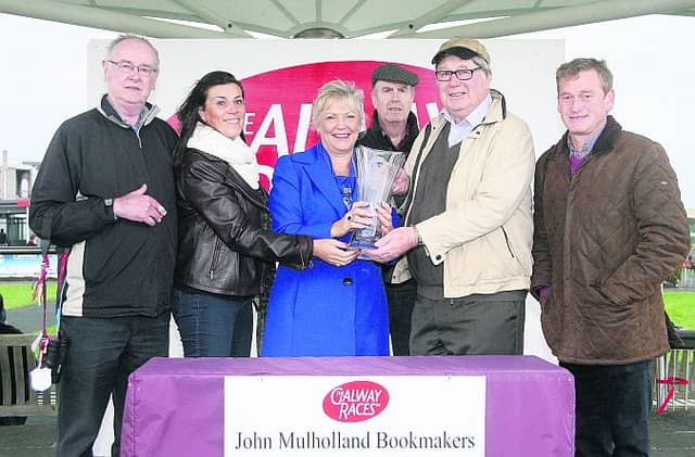 Mary Feeney presents the winning trophy to Noel and Michael Burke and Pat Folan, members of the Shoot A Hoop Syndicate, after Battling Boru won the John Mulholland Bookmakers Handicap Hurlde at Ballybrit on Monday. Also included are Olive Walsh and Tony Mullins, trainer. Photo: Iain McDonald.