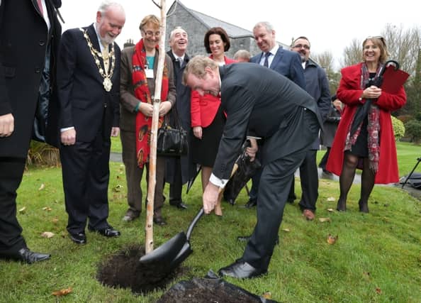 Taoiseach Enda Kenny plants a Silver Birch tree on the grounds of the Sisters of Mercy convent at Forster Street, where the new domestic violence refuge is to be developed.