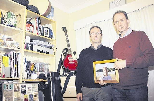 Call....Patrick and Stephen Fitzpatrick, holding a photograph of Matthew at the family home in Portumna last year.
