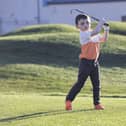 Six year-old golfer John Holland practices his golf swing at Galway Golf club. 