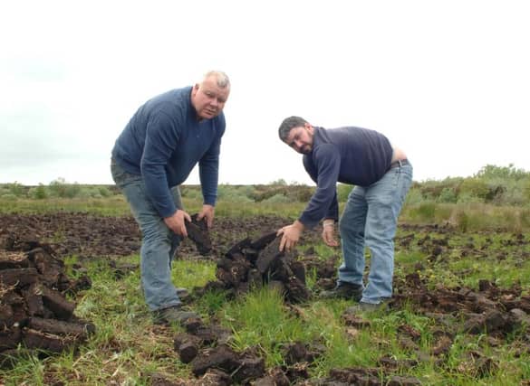 Deputy Mick Fitzmaurice and Cllr. Des Joyce footing turf on one of the designated bogs near Ballymoe.