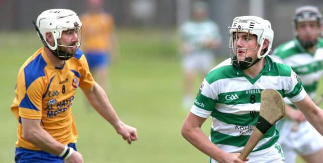 Mullagh's Sean Hardiman eyes up his options as Portumna's Patrick Dolphin closes in during Friday evening's senior hurlinmg championship tie at Duggan Park. Photos: Joe O'Shaughnessy.