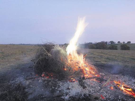 The burning of copper wire to extract the valuable metal.