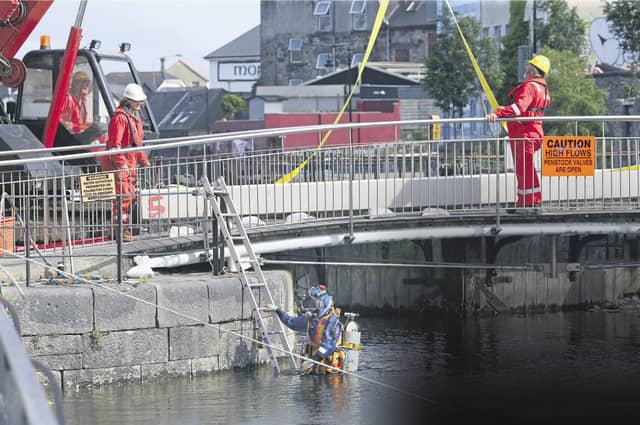 A diver enters the water at Parkavara to assess the condition of the 19th century lock gates as part of the expert report. Photo: Joe O'Shaughnessy.