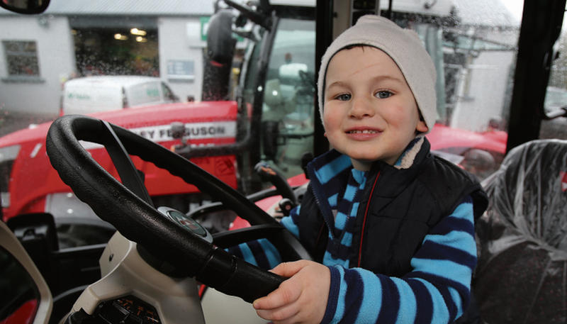Matthew Connolly (2) from Corofin takes to the wheel of a new Massey at the McHale Farm Machinery Open Day in Athenry.