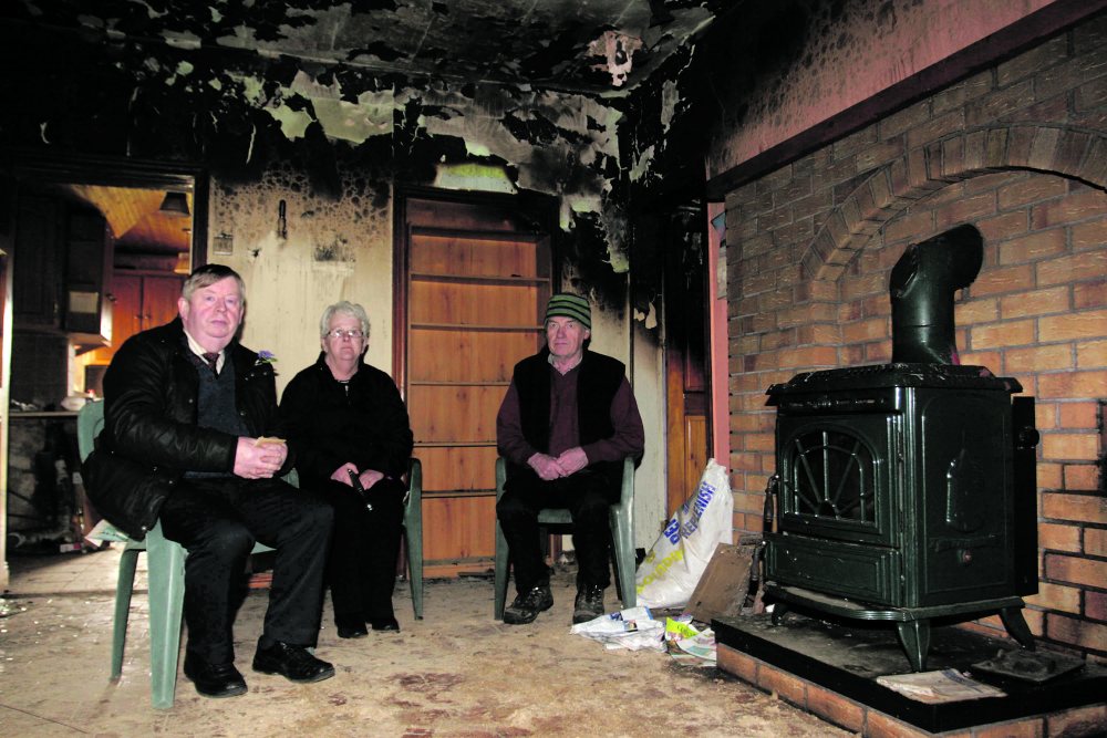 Moylough couple Billy and Marian Staunton access the fire damage to their home in Moylough with Cllr Michael Connolly (left). Photo: David Walsh.