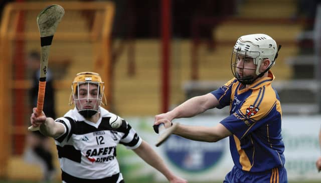 Loughrea's Alan Cormican prepares to clear his lines against Turloughmore's Barry McDonagh during the clubs' championship tie at Kenny Park on Sunday evening. Photos: Joe O'Shaughnessy