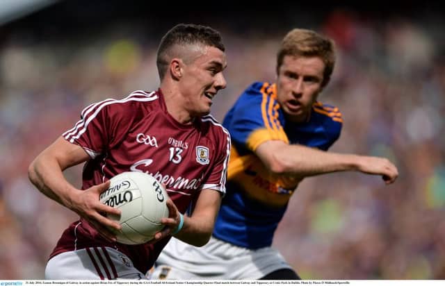 Galway's Eamon Brannigan breaking away from Tipperary's Brian Fox at Croke Patrk on Sunday.