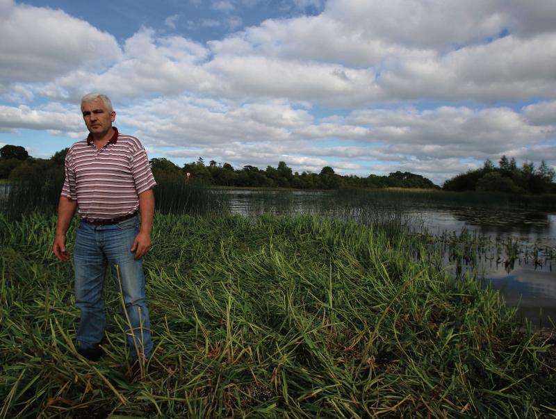 Tom Turley, standing on one of the many land encroachments that impede water flow along the river near Clonfert. PHOTO: HANY MARZOUK.