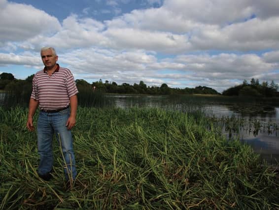 Tom Turley, standing on one of the many land encroachments that impede water flow along the river near Clonfert. PHOTO: HANY MARZOUK.