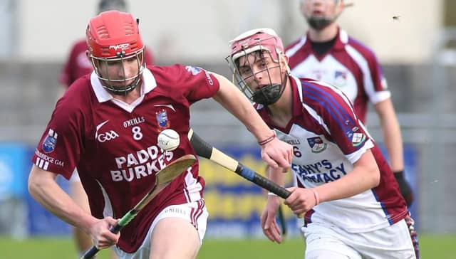 Clarinbridge's Patrick Foley is chased by Kilnadeema/Leitrim's Stephen Molloy at Kenny Park on Sunday.