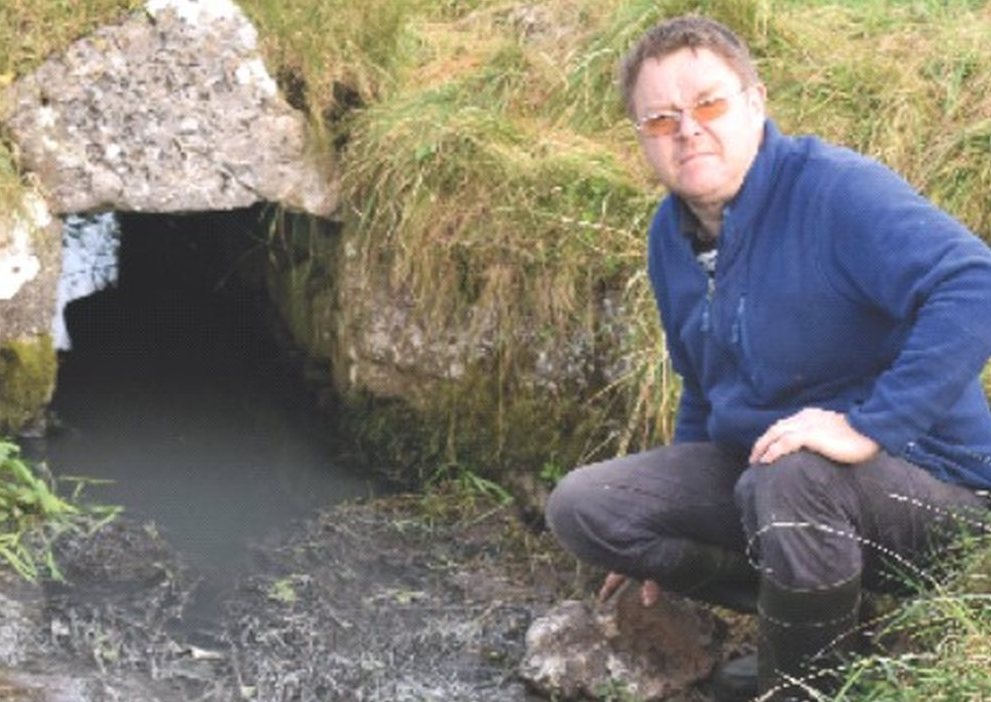 Tuam farmer Tommy McDonagh at the stream through his land which is polluted.