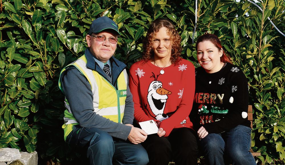 Postman Celsus Sheridan from Woodlawn handing the famous letter to Nicole Lally, "Your Wan", The Lady, Annagh, Ballymacward, joined by sending of the letter Amanda McCallan from Athlone - joined by the hens and ducks belong to your wan! Pic: Gerry Stronge.