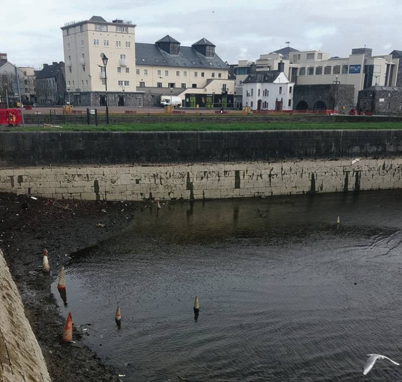 Some of the traffic cones and other litter in the partially-drained Claddagh basin.