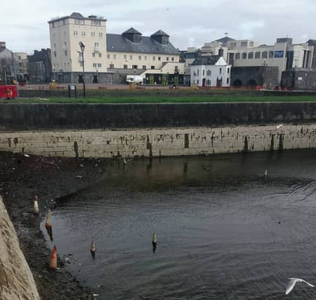 Some of the traffic cones and other litter in the partially-drained Claddagh basin.