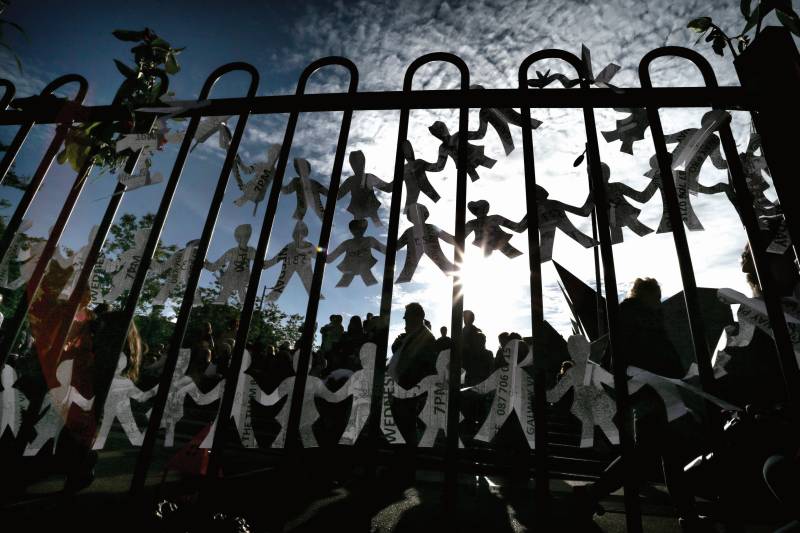 Paper dolls, representing the babies and children that died at the mother and baby home in Tuam, hang on the rails of the childrens playground at Eyre Square during a public vigil in June 2014.