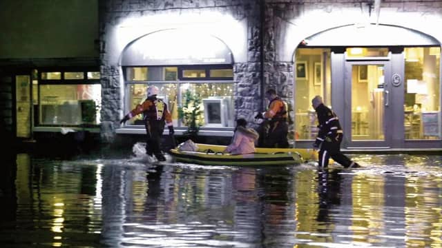 Members of Galway Fire Brigade help people getting in and out of their accomodation and homes between the flooded Fr Griffin Road and Dominick Street areas following Storm Eleanor. Photo: Joe O'Shaughnessy.