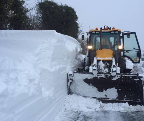 A Gaway County Council crew clearing a snow drift at New Inn, Ballinasloe.