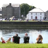 Enjoying the sunshine by the Claddagh. Photo: Joe O'Shaughnessy.