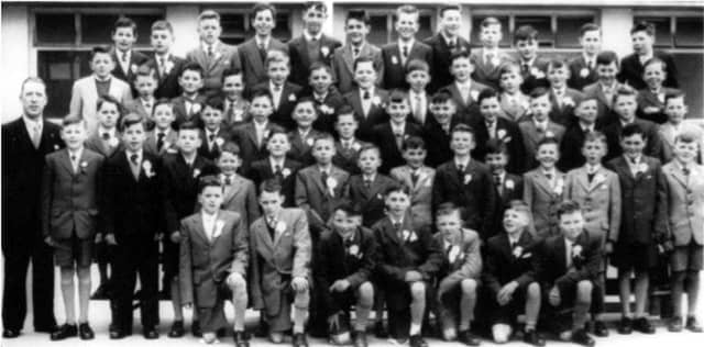 The St. Patricks National School Confirmation class of 1960. Front row, from left: Peter Salmon, Pete Molloy, Christy O'Connor Junior, Noel Lane, Johnny McCormack, and John Heaney. Second row: Teacher Tom Walsh, John Finn, Gerard Condon, Anthony McDonagh, Pete O Brennáin, Frank Kavanagh, Gerard Tierney, Eamon Howard, Tommy Morris, Pat Moloney, John Mills, .... Coleman, Austin Molloy and Martin Folan. Third row: Desmond Grant, Maurice Ward, Eddie McCormack, Seamus Furey, Joe Molloy John Shaw, Colm Flaherty, Joe Cleary, Gerard Burke, Tom Broderick, Joseph Healy, Michael Forde, and Seamus Harlowe. Fouth row: Tom Cantwell, Tom Farragher, Macdara Glynn, Arthur Quinn, James Heffernan, Willie Connell, Francis Hickey, Ollie Ryan, Michael Talbot, Kevin Duffy, Tommy Lally, Kieran Mannion and Ronnie Howard. Fifth row: Pat Walsh, Gerard Costello, Gerald McCarthy, Michael Condon, Sean Kelly, Noel Walsh, Colm O’Brien, Domnick Healy, Patsy Murphy, Tommy Jordan, Frederick Ryan and Ronnie Murphy.