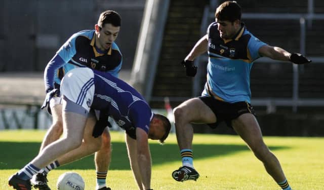Cathal Blake of Milltown is challenged by Andrew Butler and John Maher of Salthill Knocknacarra in the sides' quarter-final replay in Pearse Stadium on Sunday. Photos: Iain McDonald.