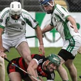Cappataggle's James Garvey finds himself surrouned by the Sarsfields' trio of Eric Kenny, Peter English and Noel Kelly in Kenny Park on Sunday. Photos: Joe O'Shaughnessy.

