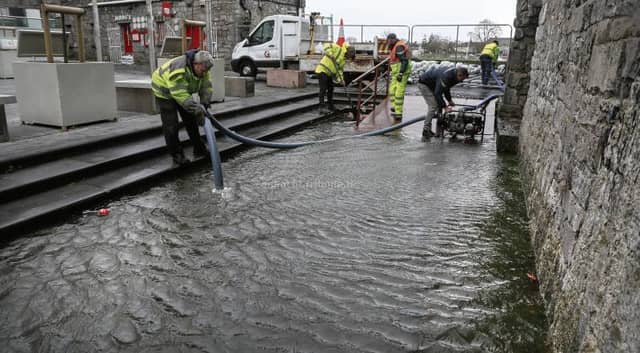 Galway City Council workers pumping water from a flooded area behind the Spanish Arch during Storm Callum. PHOTO: JOE O'SHAUGHNESSY.