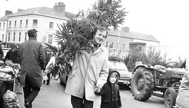 Taking home the tree - father and son outside St Patrick's NS in December 1973.