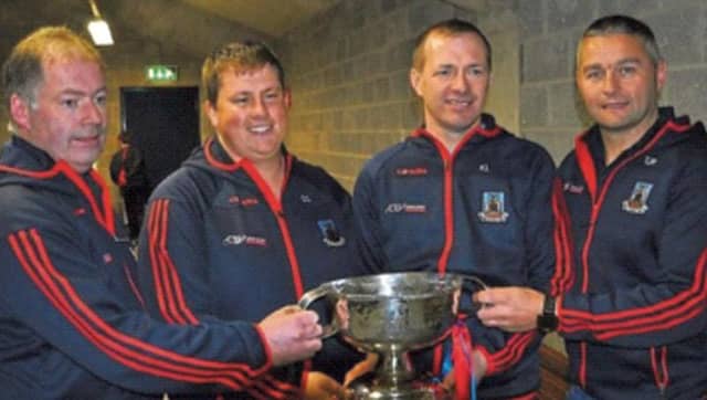The St. Thomas' management celebrate after their county SHC final victory over Liam Mellows. Left to right: Kenneth Larkin, Claude Geoghegan, Kevin Lally and TJ Ryan.