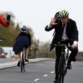 On yer bike: A frank exchange of views via sign language as Boris Johnson gets a less than complimentary greeting from a fellow cyclist on the streets of London.  