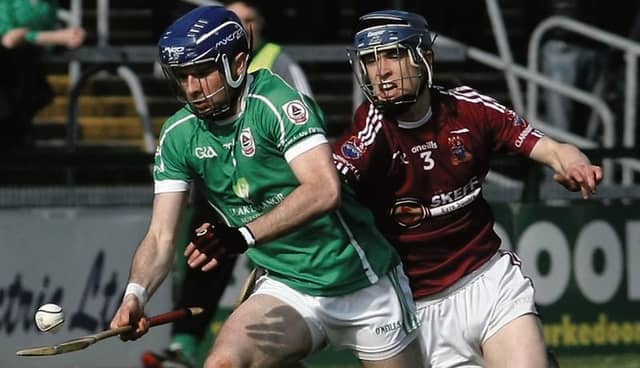 Clarinbridge’s Shane Bannon tries to halt the progress of Ballinderreen’s Roy Lane during Saturday's senior hurling championship tie at Pearse Stadium. Photos: Enda Noone.