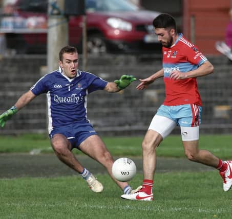 Monivea-Abbey's Paddy Mullins is about to be challenged by Caherlistrane goalkeeper Eanna Bane during the club's senior football clash at Tuam Stadium on Sunday. Photos: Joe O'Shaughnessy.