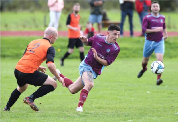Mervue United's Enda Curran turns away from the challenge of Corrib Rangers' Kevin Fitzpatrick. Photos: Joe O'Shaughnessy.