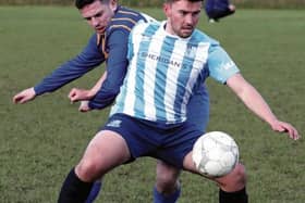 Salthill Devon's Justin Murphy shields the ball from Loughrea Rams' James Conway during the clubs' Premier Divison tie in Bushfield on Sunday. EIREFOTO