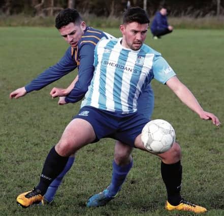 Salthill Devon's Justin Murphy shields the ball from Loughrea Rams' James Conway during the clubs' Premier Divison tie in Bushfield on Sunday. EIREFOTO