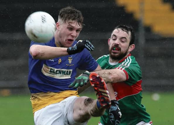 Glenamaddy's Padraig Geraghty comes under pressure from Kilmaine's David Hughes during the Connacht junior football quarter-final at Tuam Stadium on Saturday. Photos: Joe O'Shaughnessy.